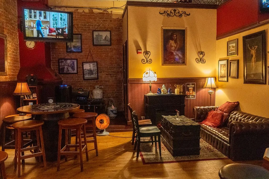 Cozy bar interior with brick wall and Chesterfield sofa.