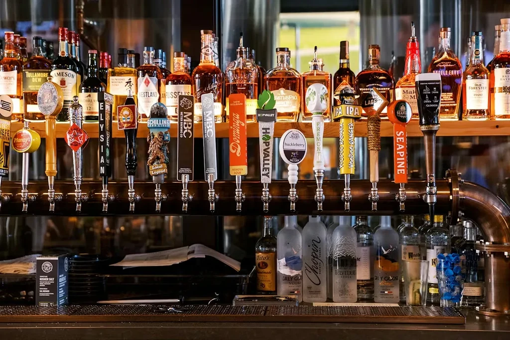 Well-stocked bar with numerous beer taps and liquor bottles.