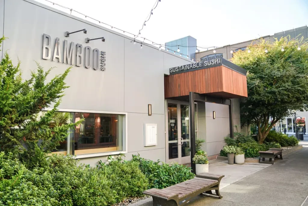 Modern Bamboo Sushi restaurant exterior with a "Sustainable Sushi" sign.