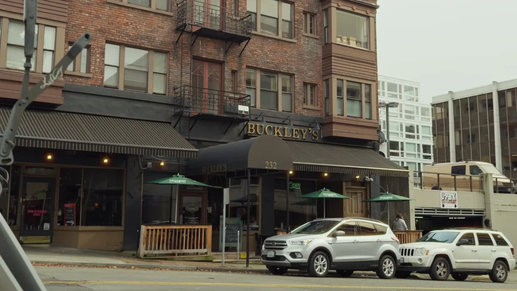 Buckley's brick restaurant building, outdoor seating, adjacent parking garage.