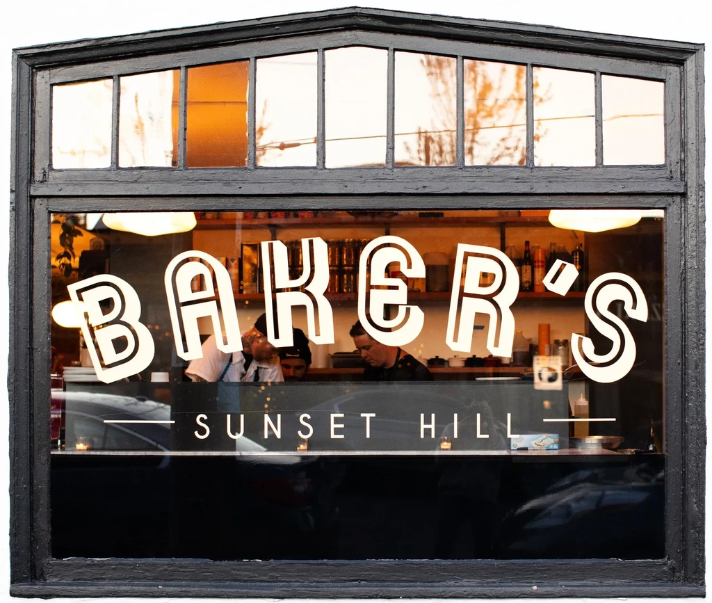 Baker's Sunset Hill's arched window shows warm interior and staff.
