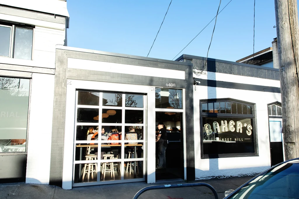 Black and white striped Baker's Sunset Hill restaurant exterior with visible patrons.