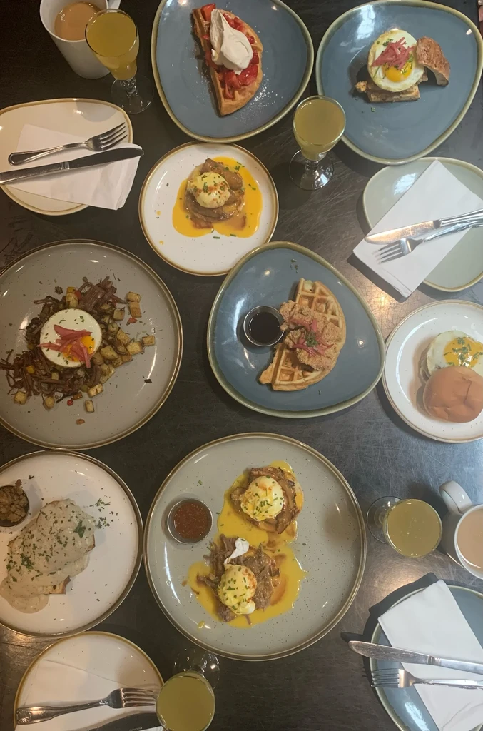 A table filled with various breakfast and brunch dishes and drinks.