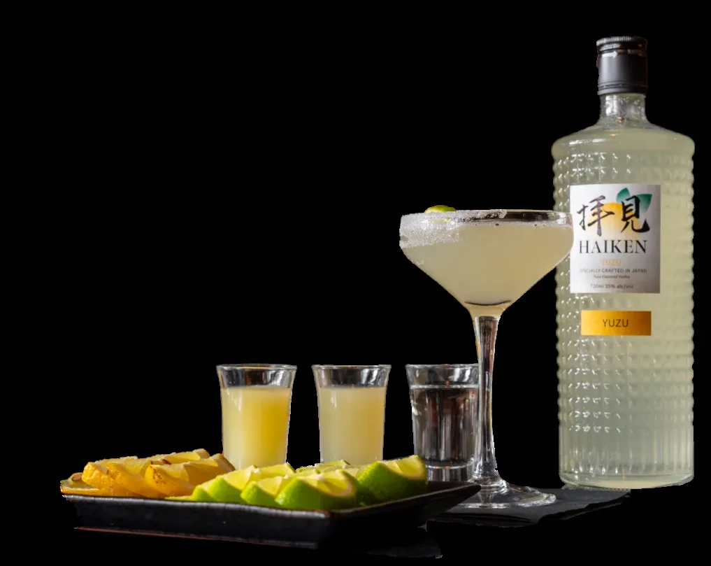 HAIKEN YUZU vodka bottle, yuzu cocktail, and citrus garnishes.