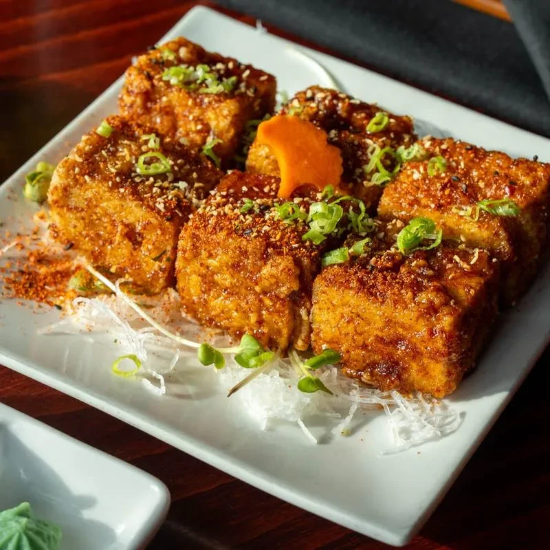 Golden crispy fried squares with spices, sesame, and green onions.