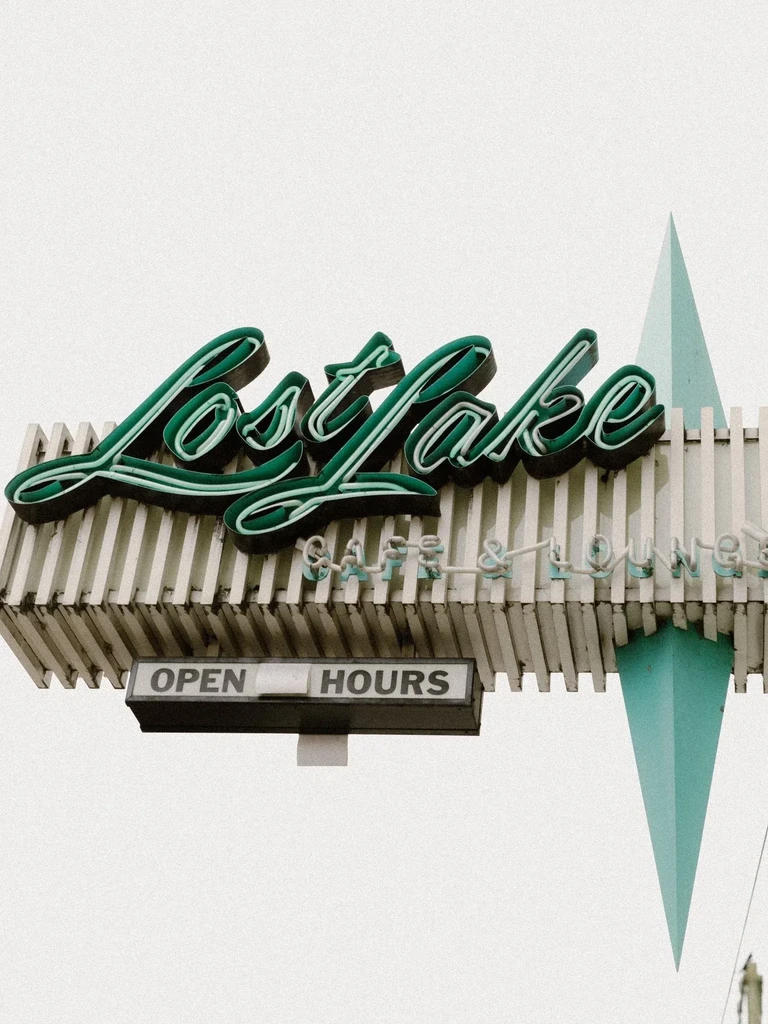 Teal retro neon sign, Lost Lake Cafe & Lounge, with triangle.