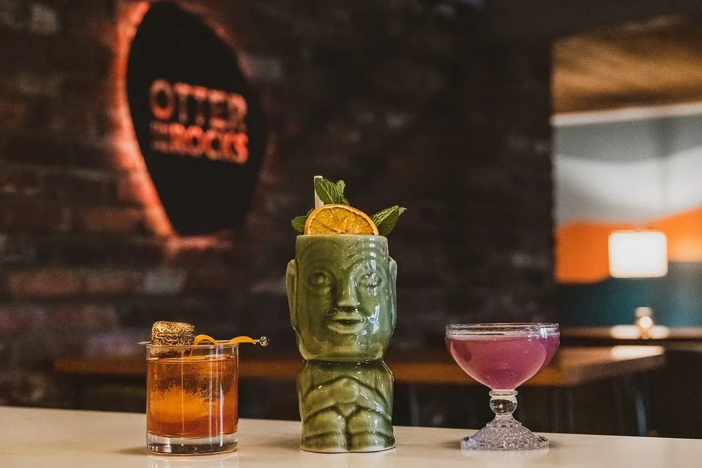Three unique cocktails: amber, tiki, and purple, at Otter on the Rocks.