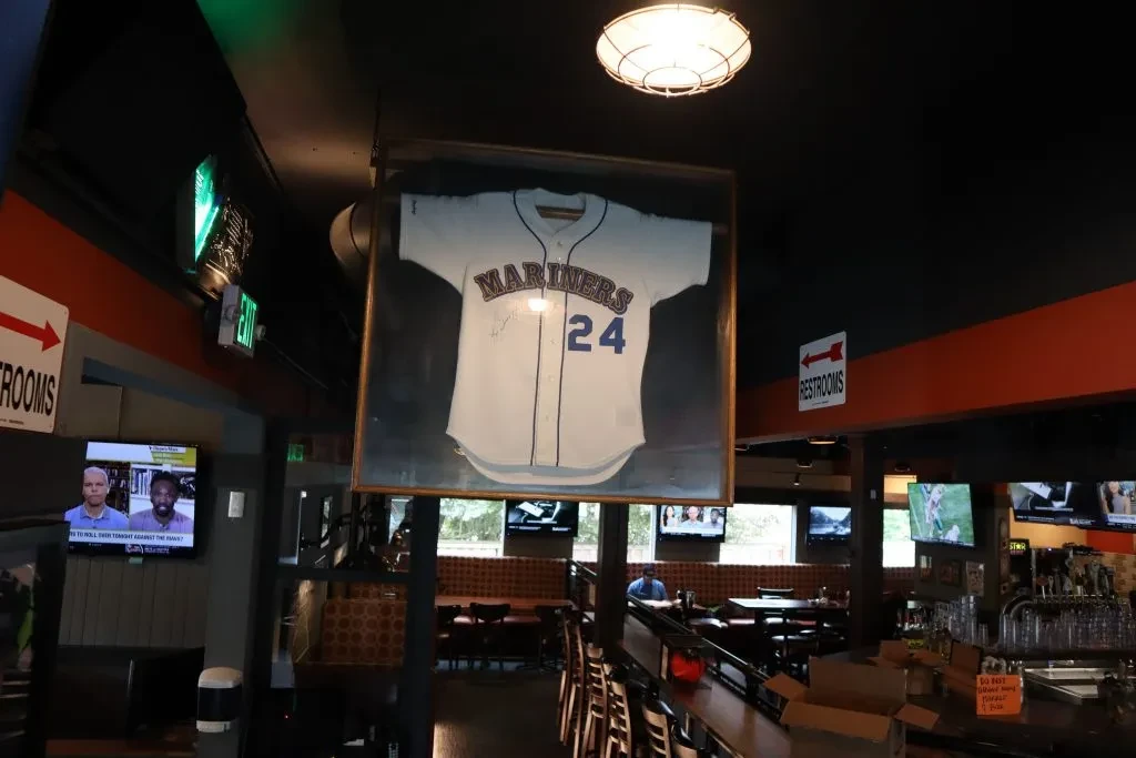 Autographed Seattle Mariners #24 jersey hangs prominently in a sports bar.