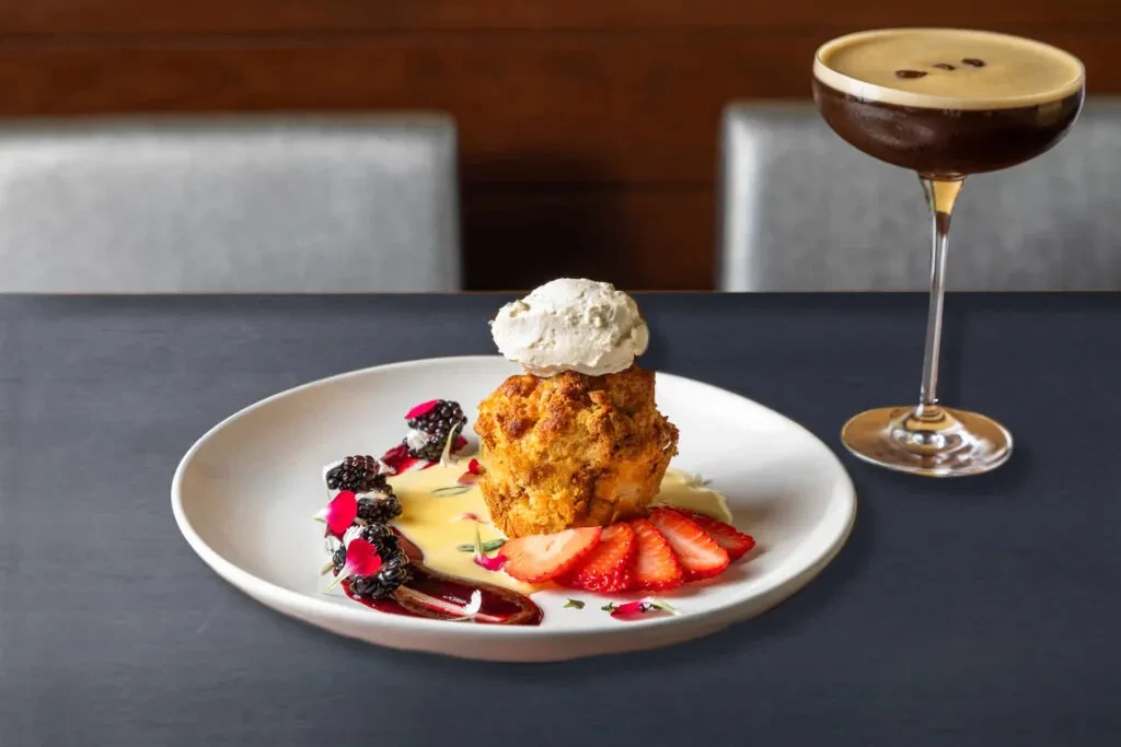 Golden-brown baked dessert, berries, ice cream, and an espresso martini.