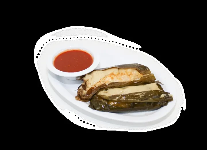 Two leaf-wrapped dishes, with orange sauce, on a white plate.