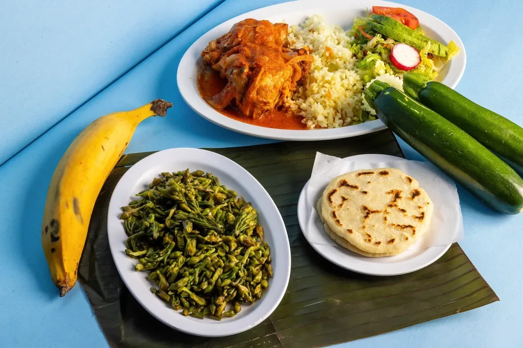 Overhead view: Traditional meal of meat, rice, vegetables, flatbreads, fresh produce.