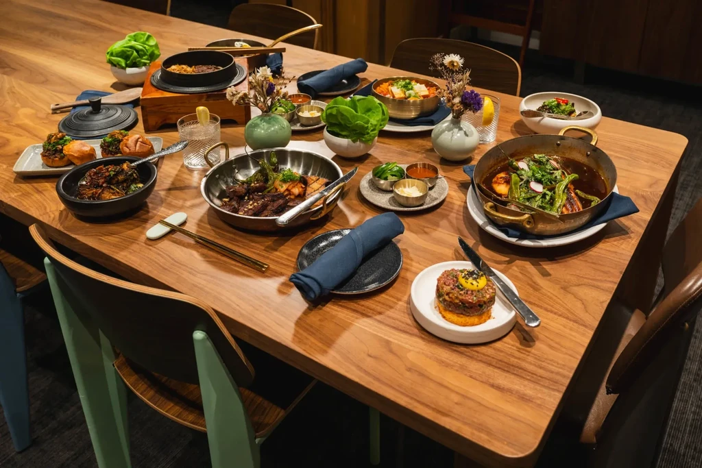 Restaurant table laden with beautifully arranged food and beverages.