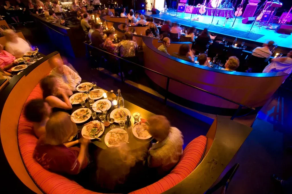 Elevated view of a sophisticated, lively dinner club with live music.