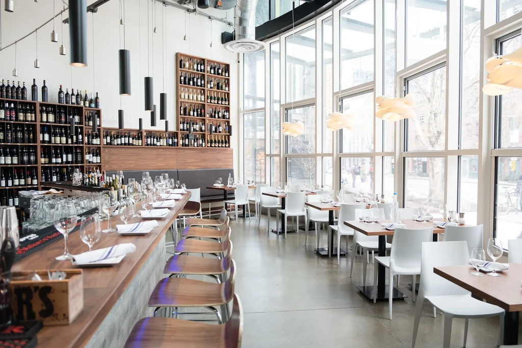 Sleek, modern restaurant with a wine bar and sunlit dining area.