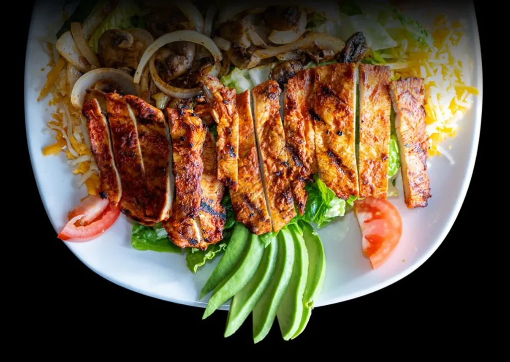 Grilled chicken breast, lettuce, avocado, tomato, cheese, onions, mushrooms.