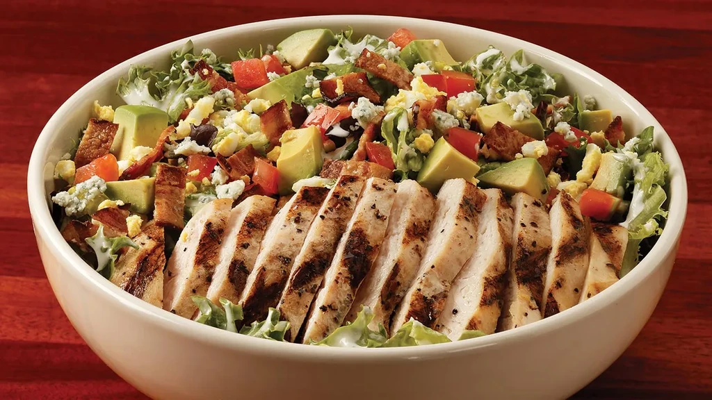 Grilled chicken Cobb salad with avocado, bacon, blue cheese, and egg.
