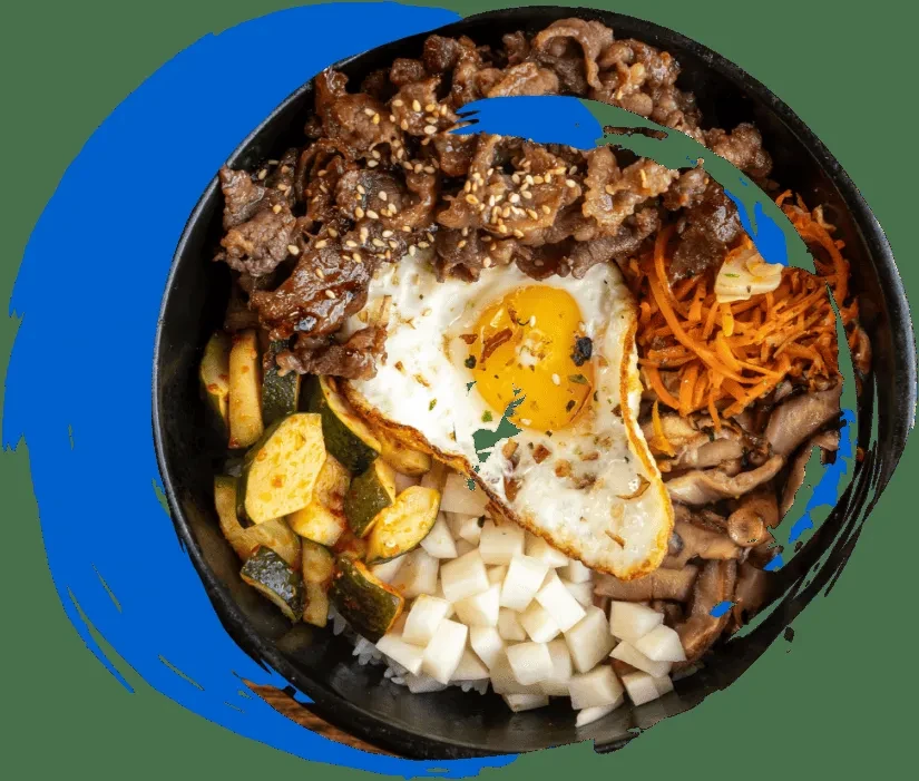 Overhead bibimbap with beef, vegetables, and a fried egg.