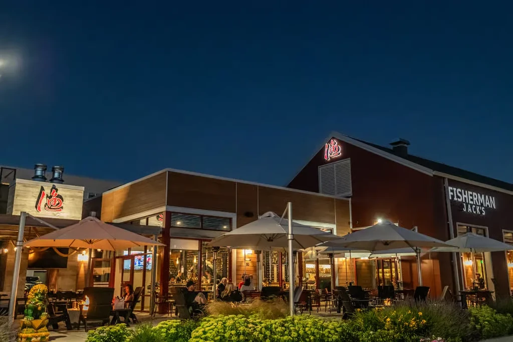 Fisherman Jack's restaurant with lively patio and fire pits at dusk.