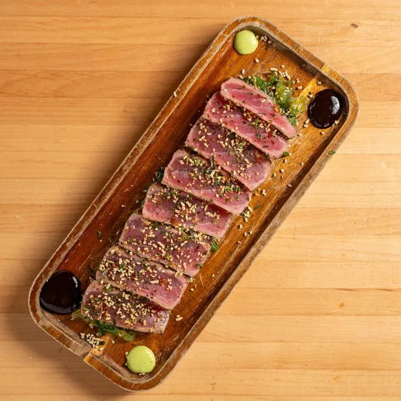 Seared tuna slices, sesame, green seaweed salad, two sauces.