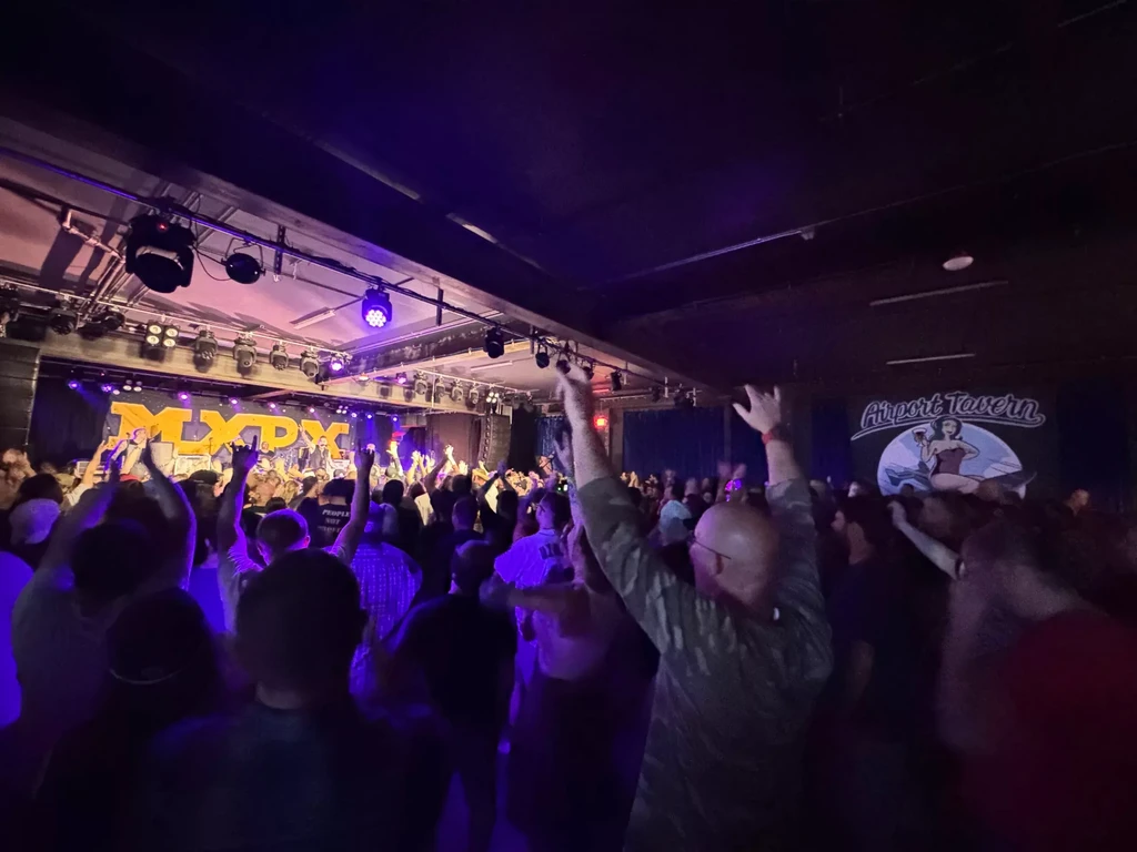 Crowd with raised hands at an MXPX concert in Airport Tavern.