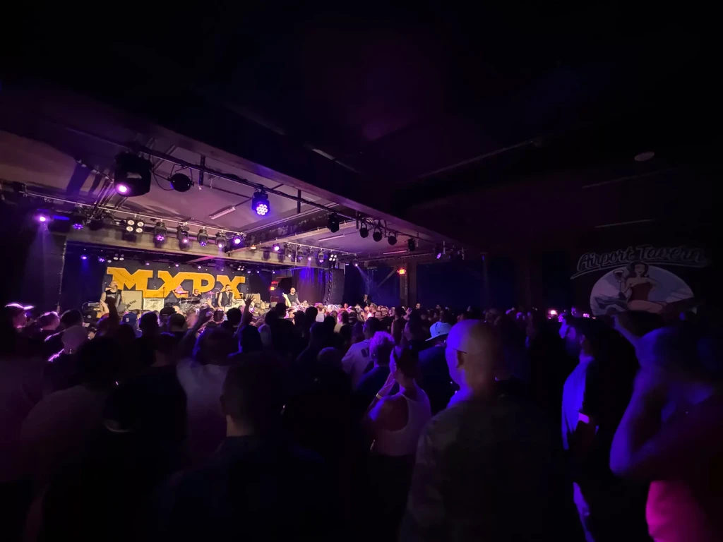 MXPX band performs on stage for an energetic crowd at Airport Tavern.