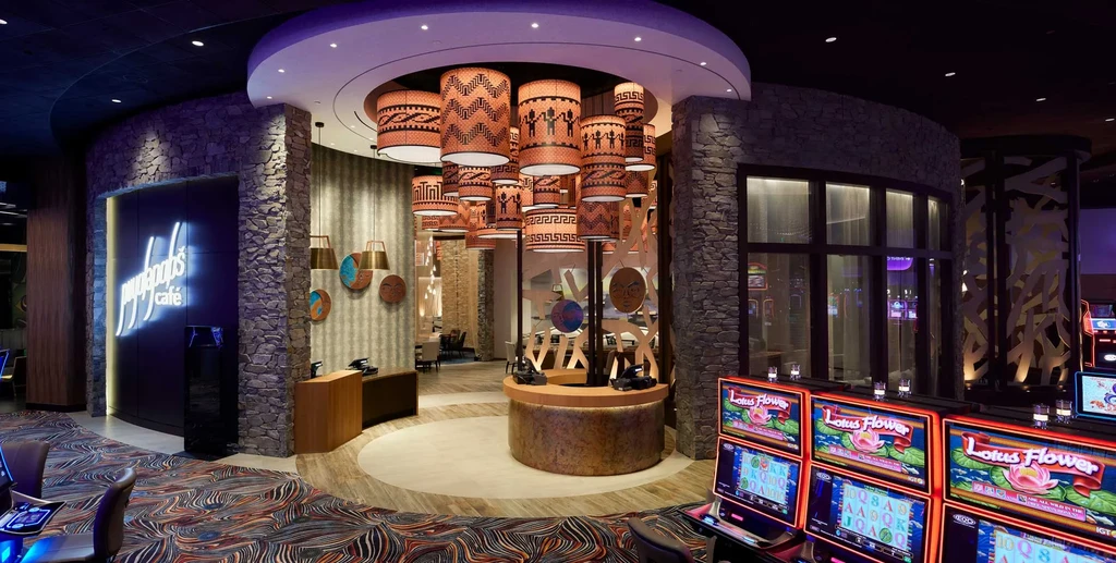 Myron's Café glowing entrance, ornate lamps, and casino slot machines.