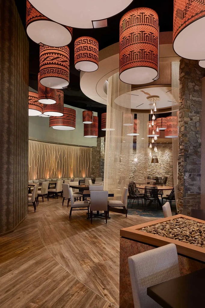 Elegant, modern rustic restaurant interior featuring unique lighting and textures.