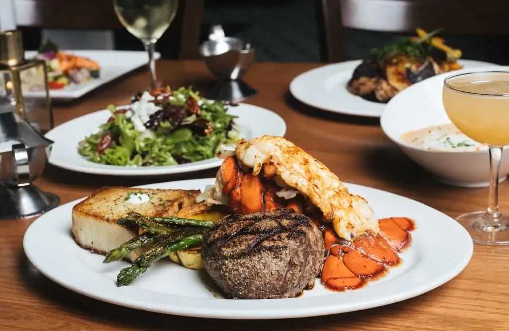 Fine dining surf and turf meal of steak, lobster, and asparagus.