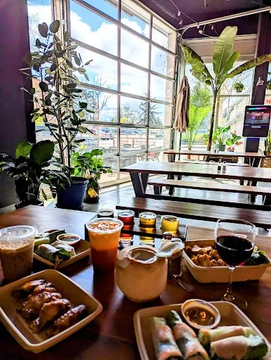 A table with diverse food and drinks in a modern restaurant.