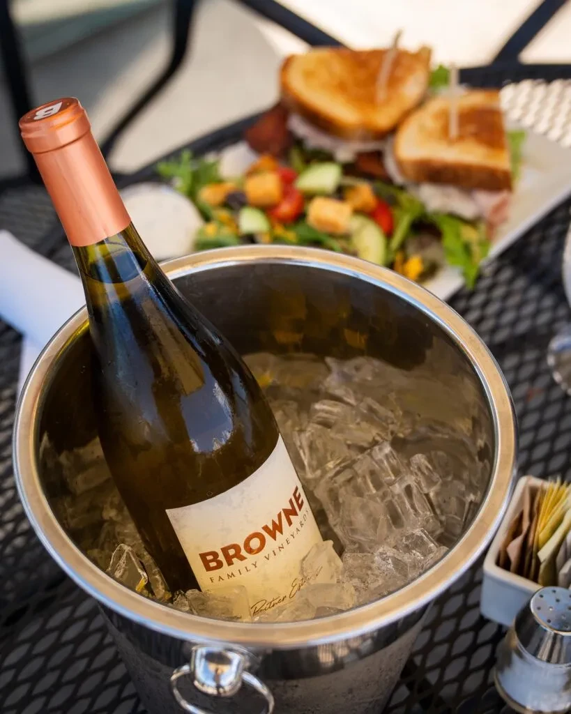 Browne Family Vineyards white wine chilling in an ice bucket at outdoor dining.