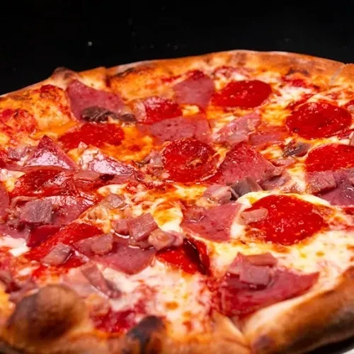 Freshly baked pizza with bubbly cheese, pepperoni, and various meat toppings.