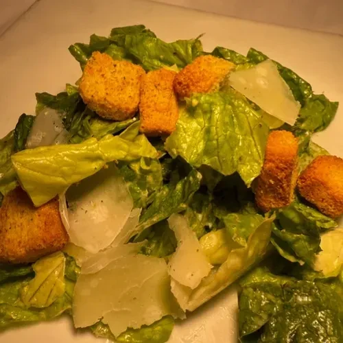 Caesar salad with romaine, croutons, Parmesan, and dressing.