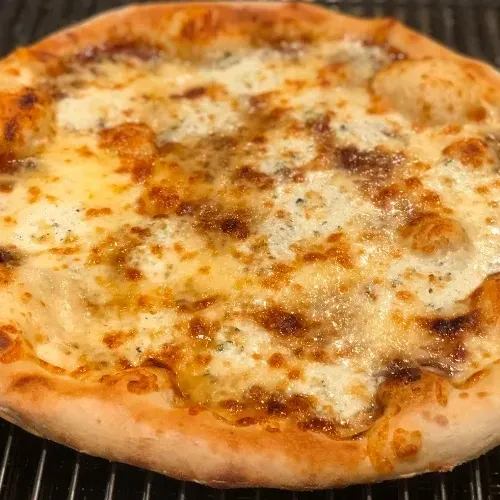 Freshly baked white pizza with melted cheese, golden crust, and herbs.
