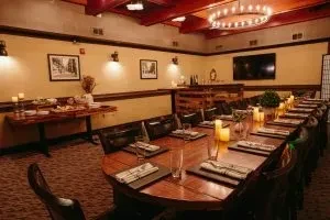 Warmly lit private dining room with elegantly set table and buffet.
