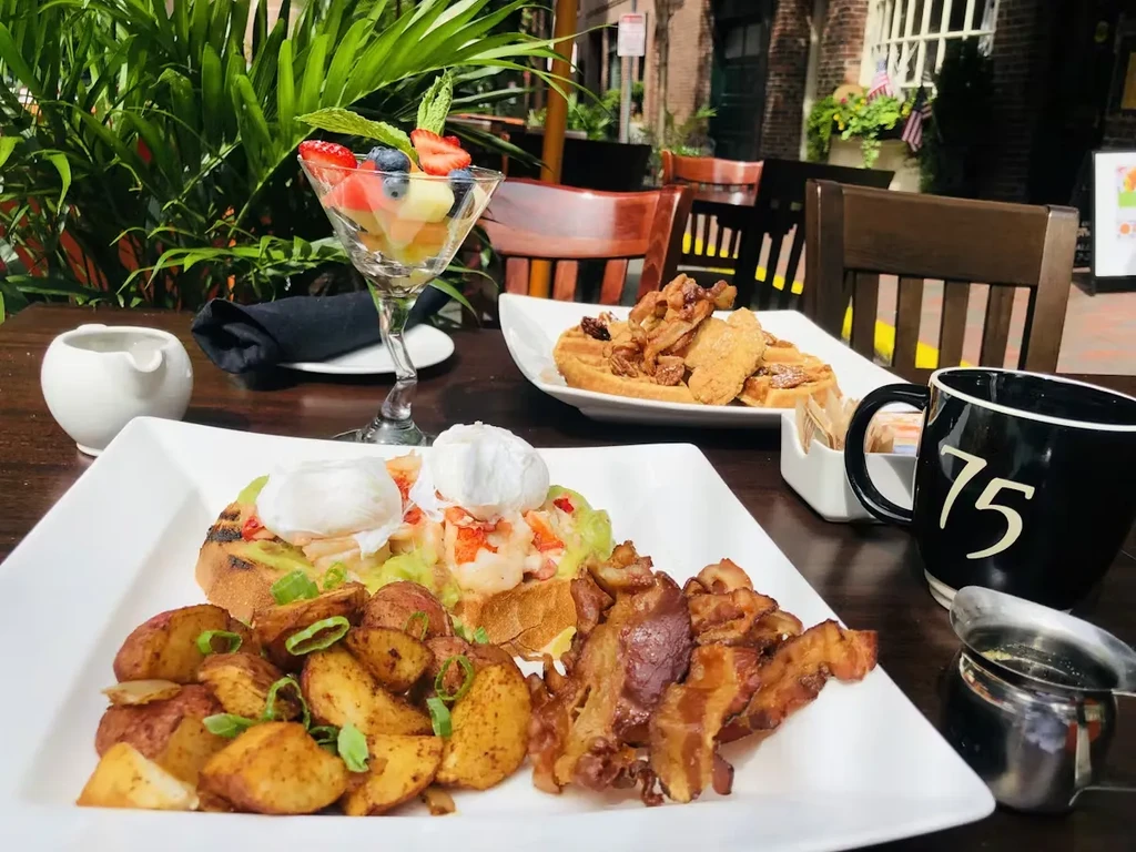 Outdoor patio restaurant table with a large breakfast and brunch spread.