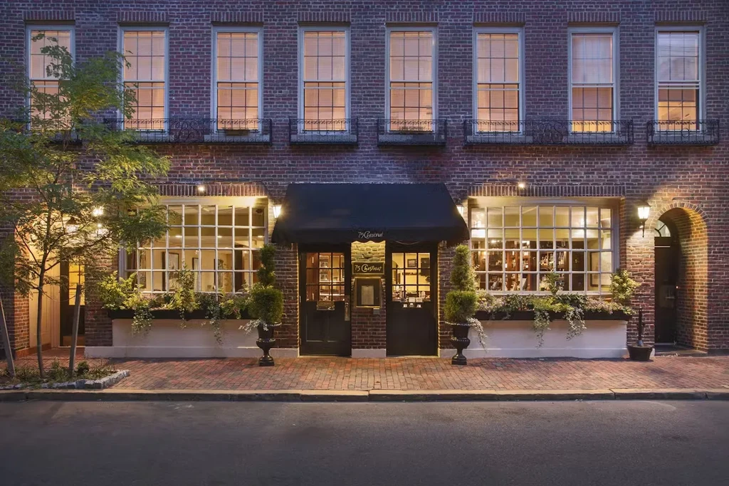 Exterior of '75 Chestnut' brick building, warmly lit at night.