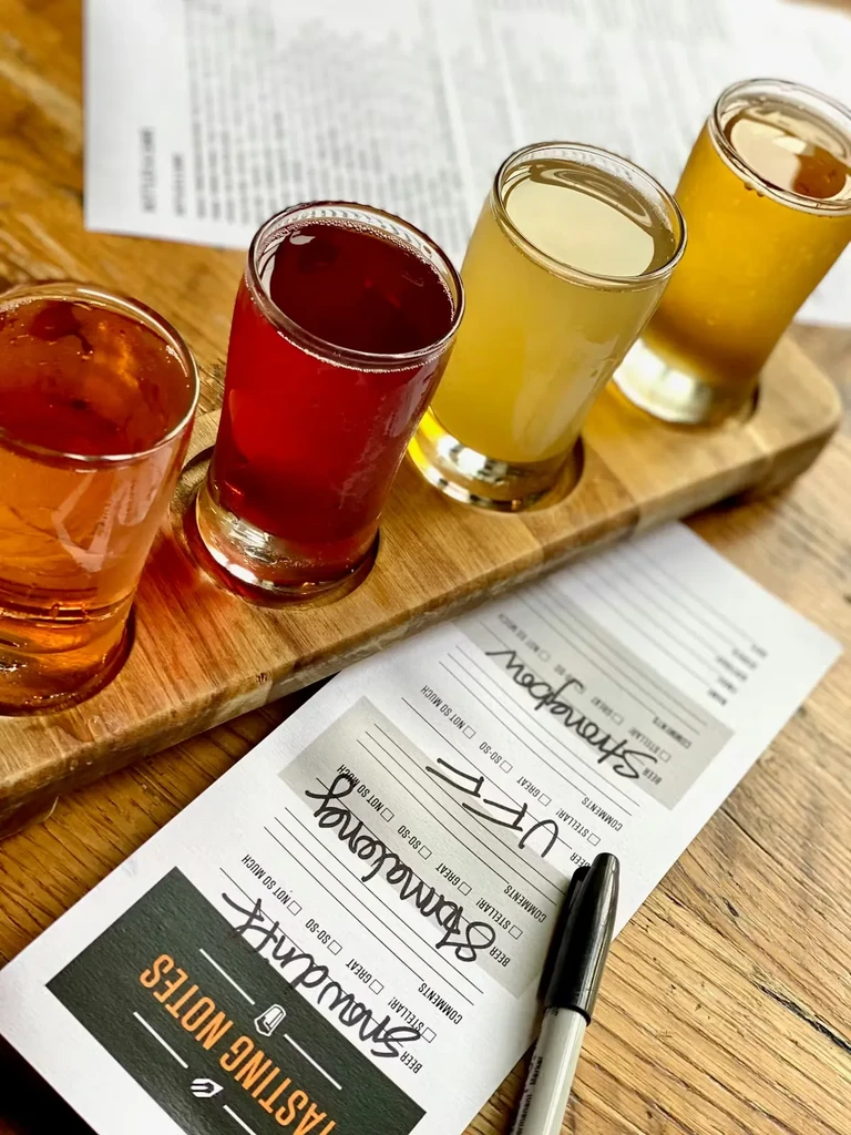 Four different beverages in a tasting flight with notes.