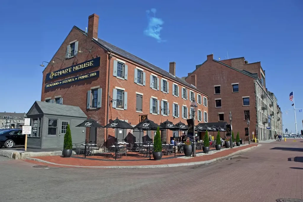 Historic brick Chart House restaurant with outdoor dining on a sunny day.