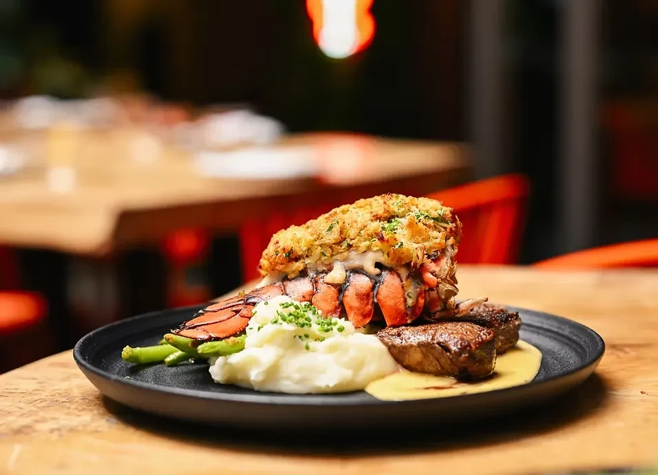 Upscale surf and turf: lobster tail, steak, potatoes, green beans.