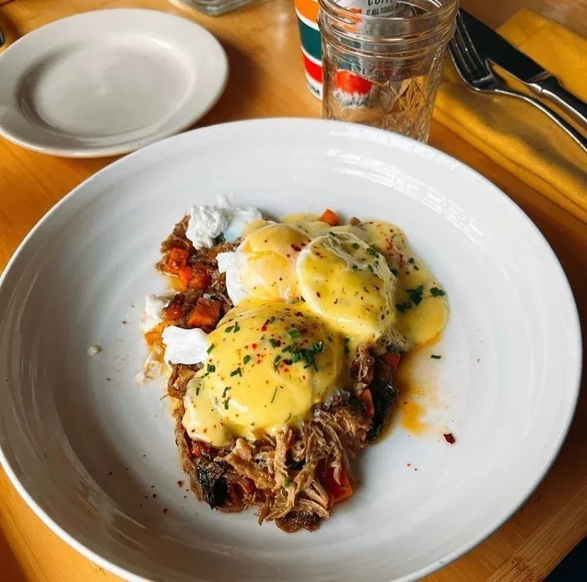 Poached eggs with hollandaise over pulled pork and roasted vegetables.