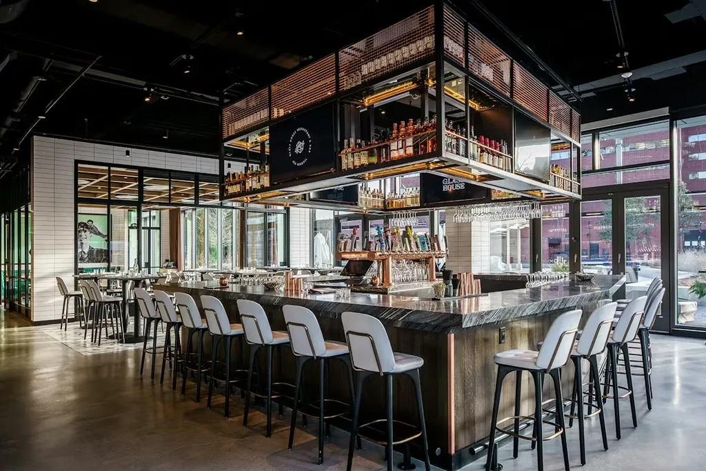 Stylish Glasshouse Restaurant & Bar interior with prominent liquor display.