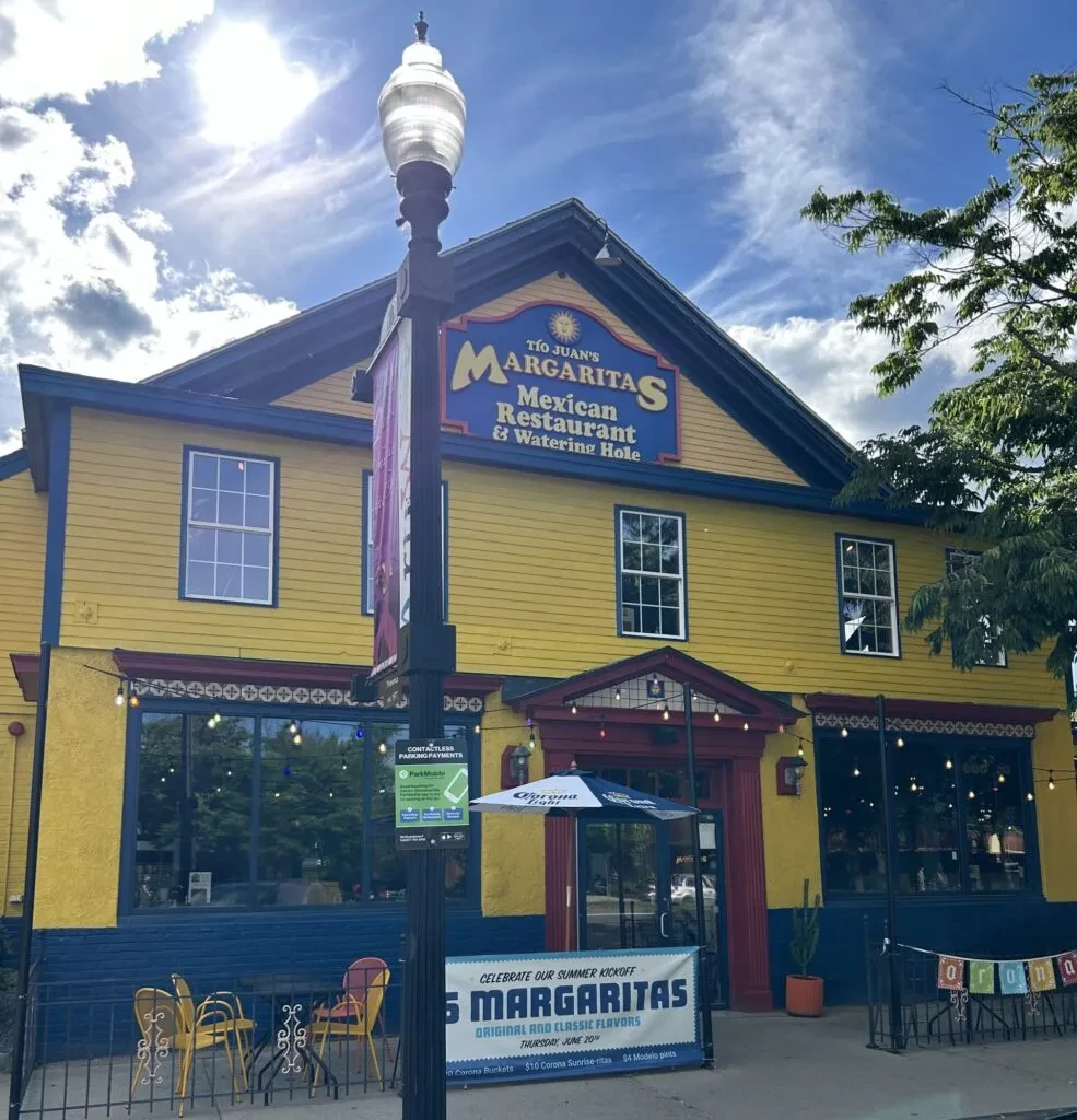 Vibrant yellow Tío Juan's Mexican restaurant exterior, sunny day.