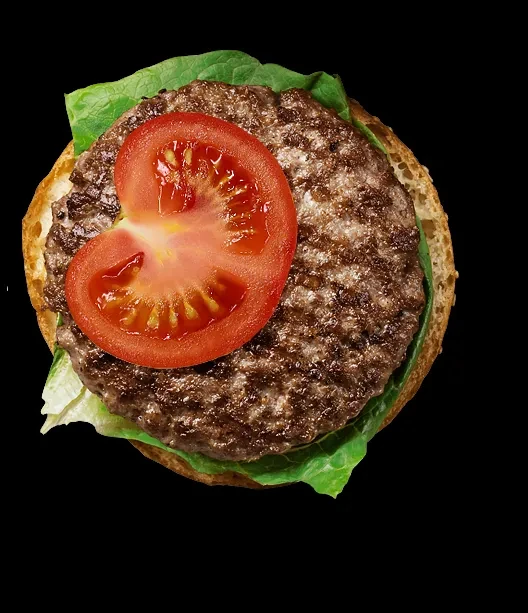 Top-down, open-faced hamburger with patty, lettuce, tomato, sesame bun.