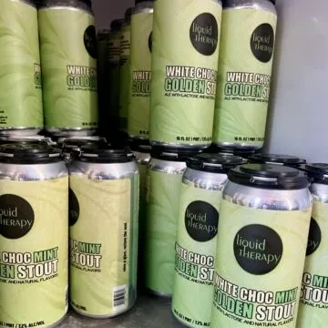 Numerous liquid therapy choc mint craft beer cans displayed.
