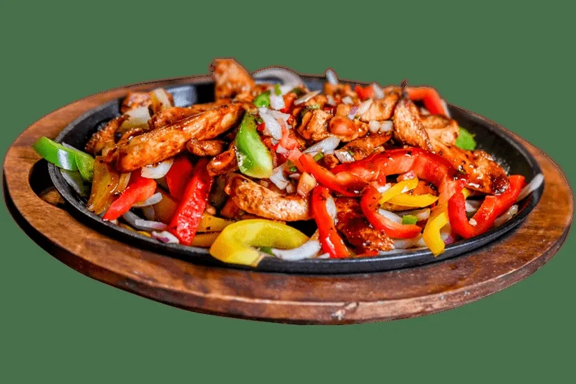 Chicken fajitas with bell peppers and onions in a sizzling skillet.