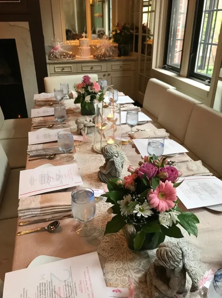 Elegant dining table set for Alyssia's First Holy Communion with flowers and cake.