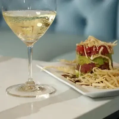 Sparkling wine and layered tuna tartare with crispy toppings.