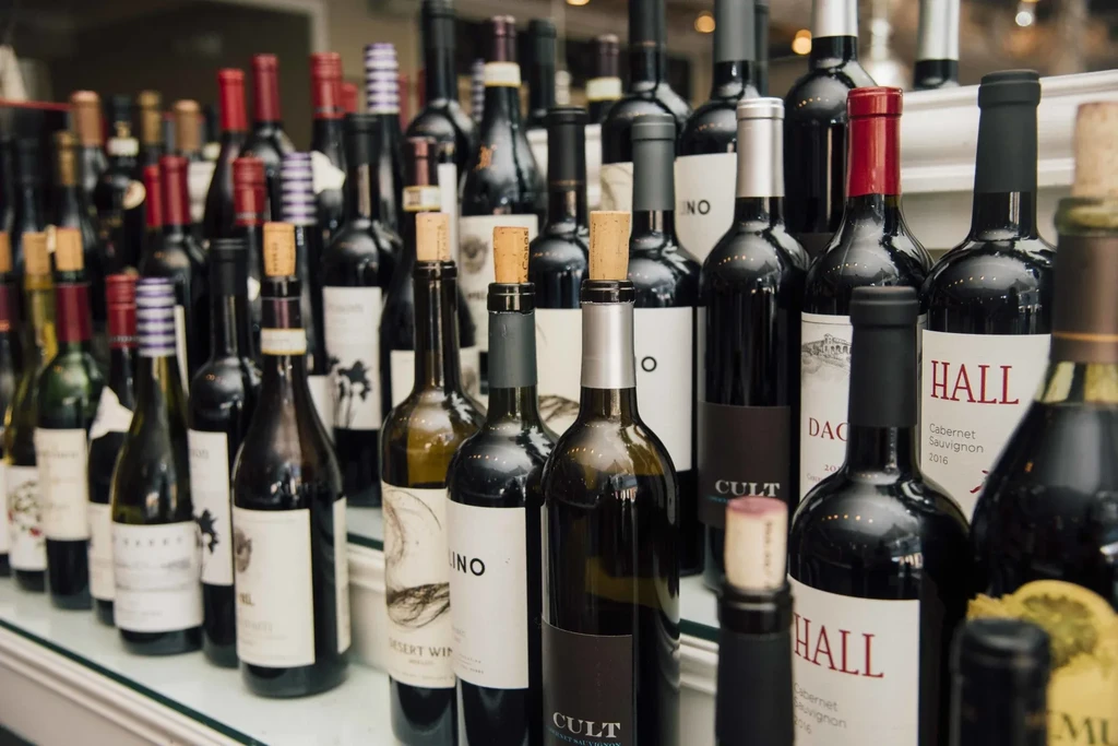 Numerous dark glass wine bottles displayed in a professional setting.