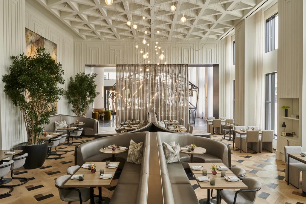Elegant modern restaurant interior with set tables and diverse seating.