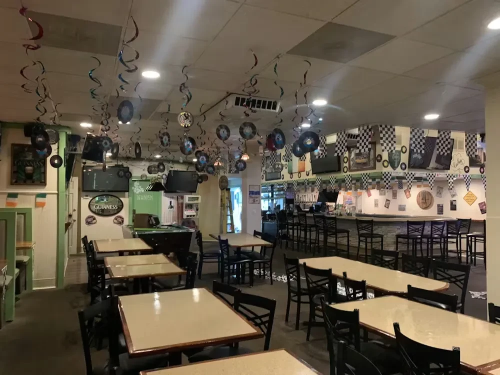 Empty bar/restaurant with patterned walls and record ceiling.